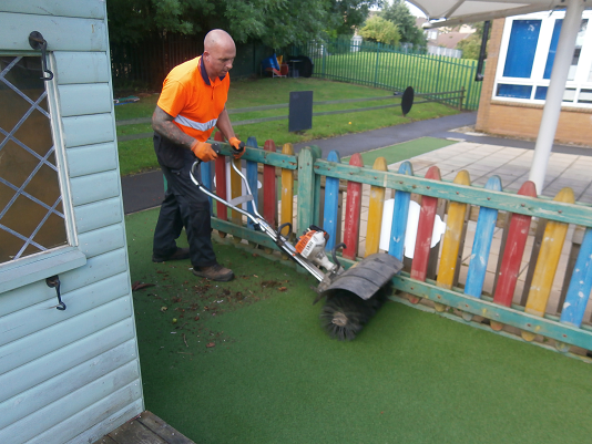 removing debris from the surface with a power brush