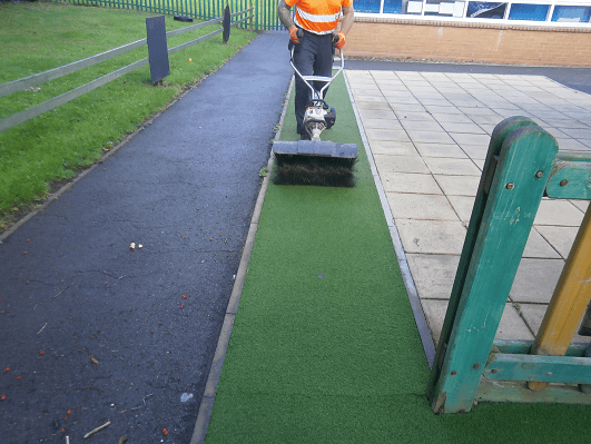 power brushing the green turf